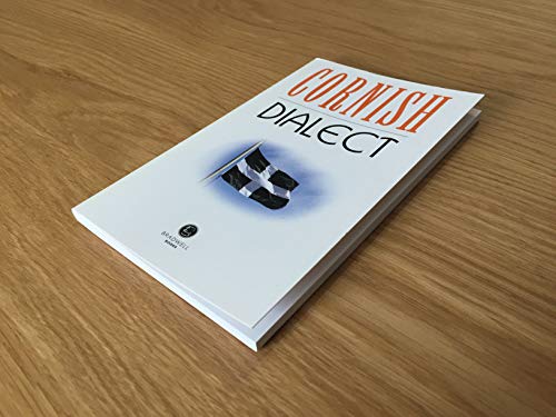 A book titled Cornish Dialect featuring a black and white flag on a wooden surface.