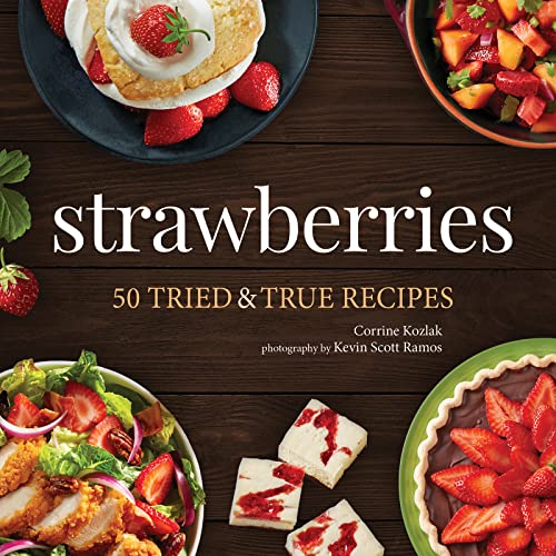 Cookbook cover featuring strawberry recipes and fresh strawberries on a wood surface.