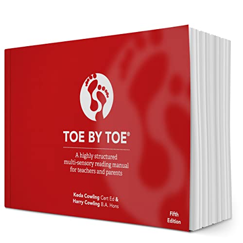 Red reading manual, “Toe by Toe,” with footprints and thick pages.
