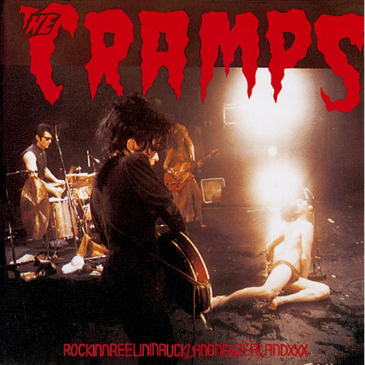 The Cramps band performing live on a dark stage, vinyl record cover.