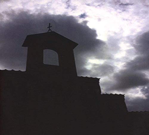Silhouetted church tower against a dramatic, cloudy sky.