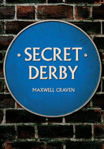 Blue circular plaque reading "Secret Derby" by Maxwell Craven, brick background.