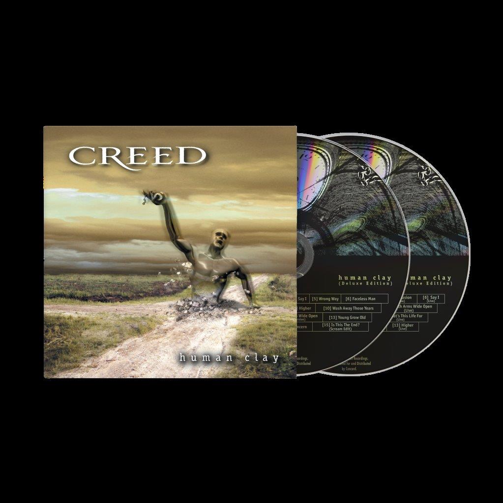 Creed’s “Human Clay” deluxe edition CD with two discs and statue imagery.
