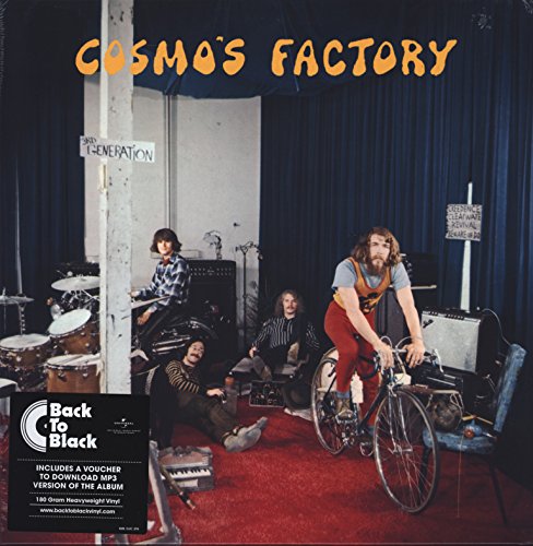 Creedence Clearwater Revival members in a studio with instruments and a bicycle.