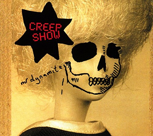 Doll with skull face paint, blonde hair, and 'Creep Show' logo on a yellow background.