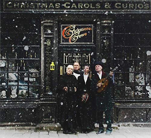 "CD cover featuring three men in black standing outside a shop in the snow."