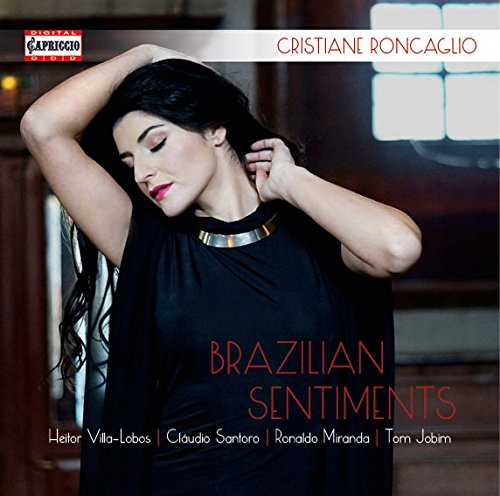 Woman in black dress on album cover with red and white text overlay.