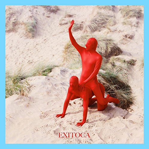 Album cover: two figures in red suits on a sandy dune.