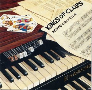 CD cover with Hammond organ keys, playing cards, and sheet music.