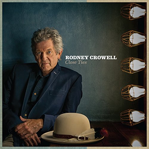 "Album cover featuring Rodney Crowell, an older man, sitting with a hat on a table."