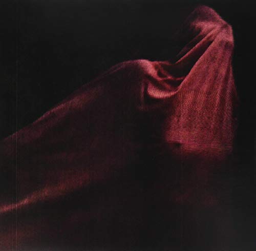 Dark red velvet fabric draped against a black background.