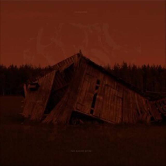 Dilapidated wooden building against a dark, reddish-orange sky and trees.