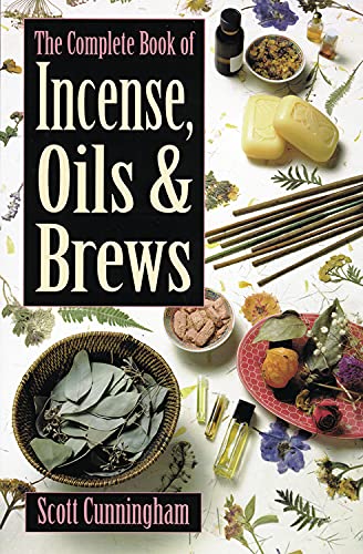 Book cover with title, herbs, oils, and incense sticks arranged around it.