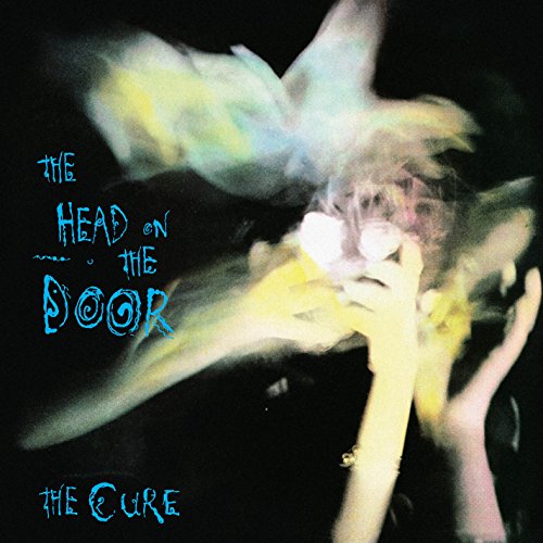 Album cover for The Cure’s “Head on the Door” with blurred figures.