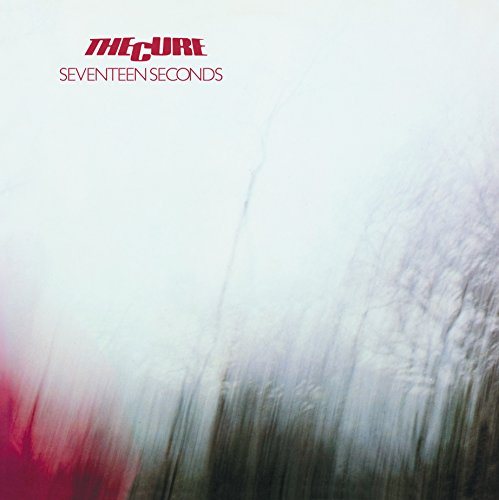 The Cure Seventeen Seconds album cover with blurry white and dark tree silhouettes.