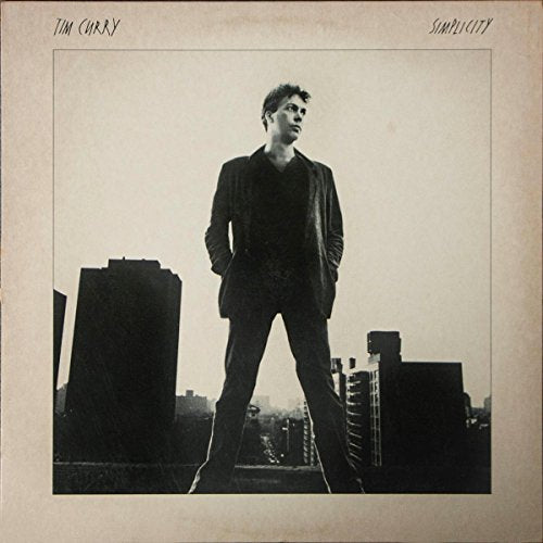 Black and white album cover featuring Tim Curry standing in a city.