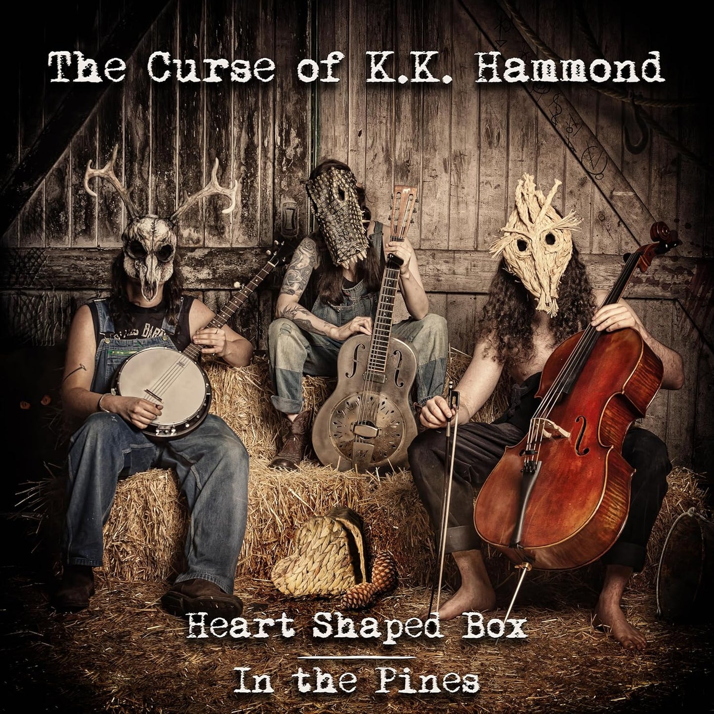 Three figures with animal skull masks playing banjo, guitar, and cello.