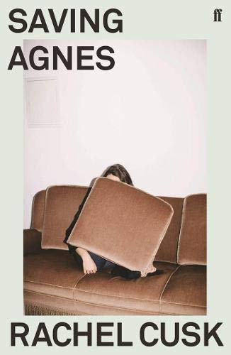 Book cover showing a person sitting on a brown sofa, hiding behind a cushion.