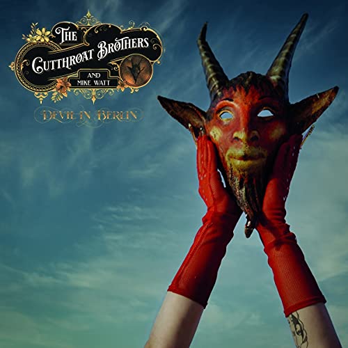 Album cover featuring a horned mask held by red-gloved hands.