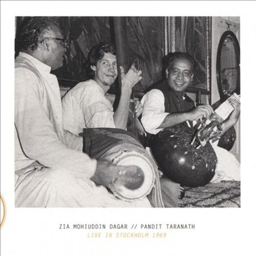 Black and white photo of three musicians with Indian instruments.