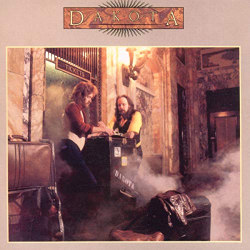 CD cover for "Dakota" featuring two men in a theater lobby.