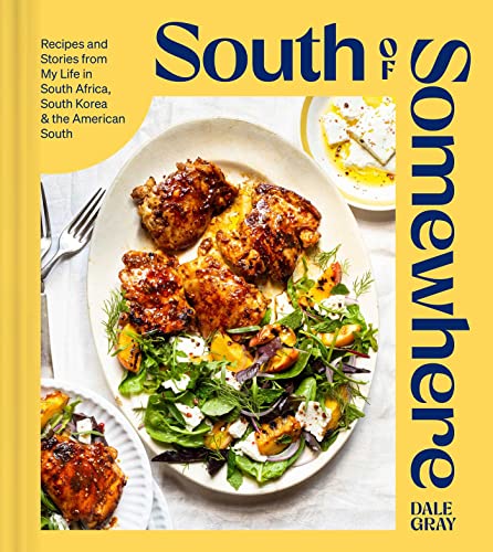 Cookbook cover featuring glazed chicken with salad on a plate.