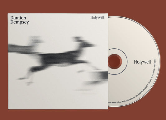 Damien Dempsey Holywell CD cover featuring a motion-blurred black animal silhouette on white background.