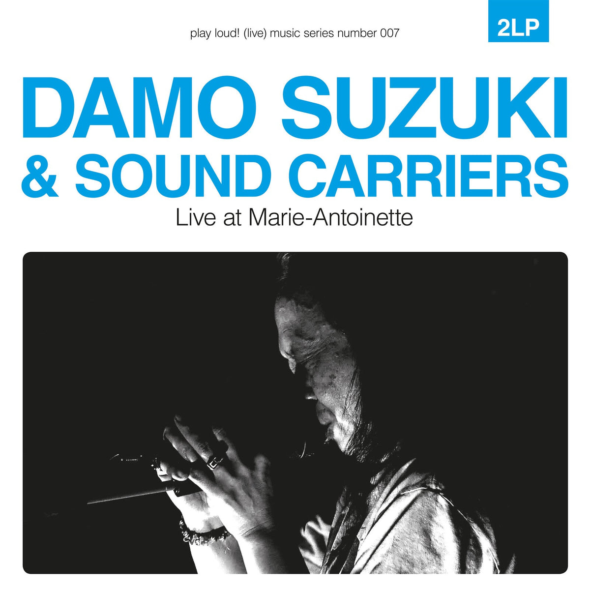 Album cover featuring Damo Suzuki singing in black and white with blue text above.