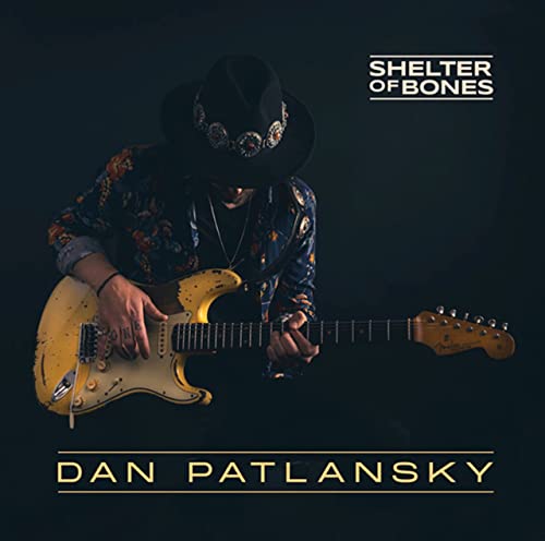 Dan Patlansky playing a sunburst electric guitar, wearing a cowboy hat.
