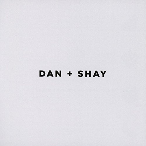 The image shows a plain light grey background with "DAN + SHAY" in black text centered.