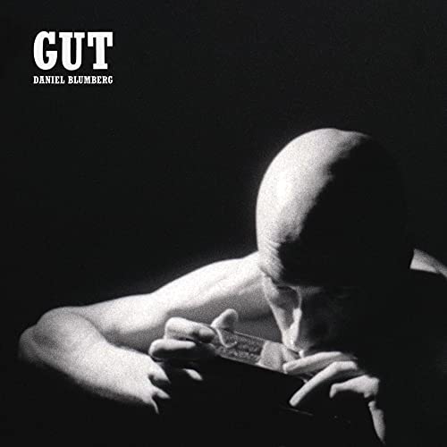 Black and white album cover featuring a person with head in hands.