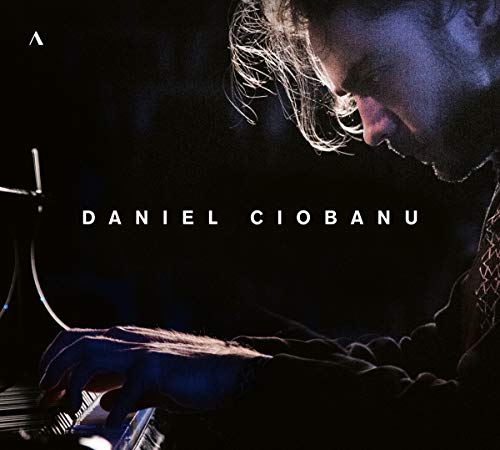 A man plays piano, head bowed, with the name "Daniel Ciobanu" in white text.