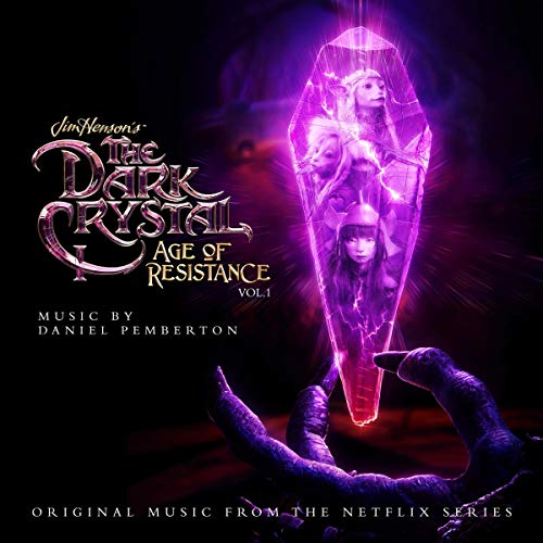 A glowing purple crystal held by a clawed hand, featuring Gelfling faces inside.