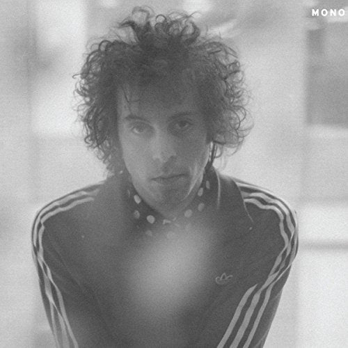 Black and white album cover featuring a man with curly hair wearing a tracksuit.