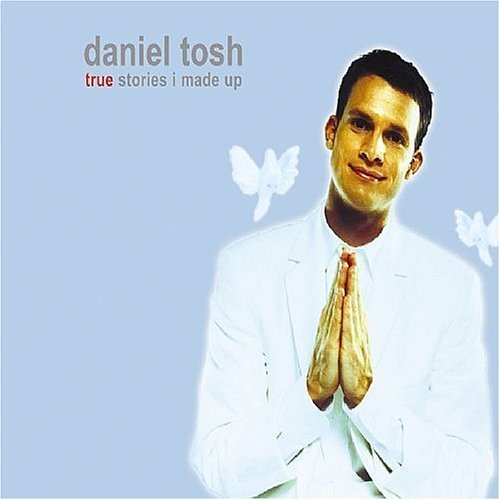 CD cover featuring comedian Daniel Tosh in a white suit, praying.