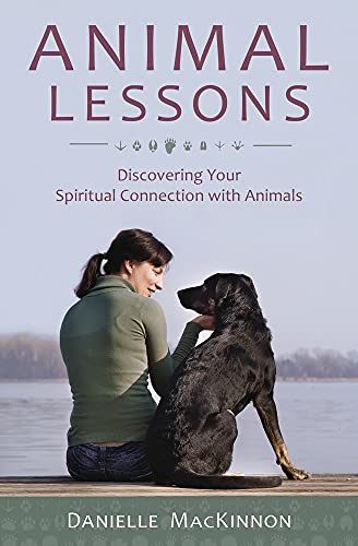 Book cover: woman with dog, titled "Animal Lessons" by Danielle MacKinnon.
