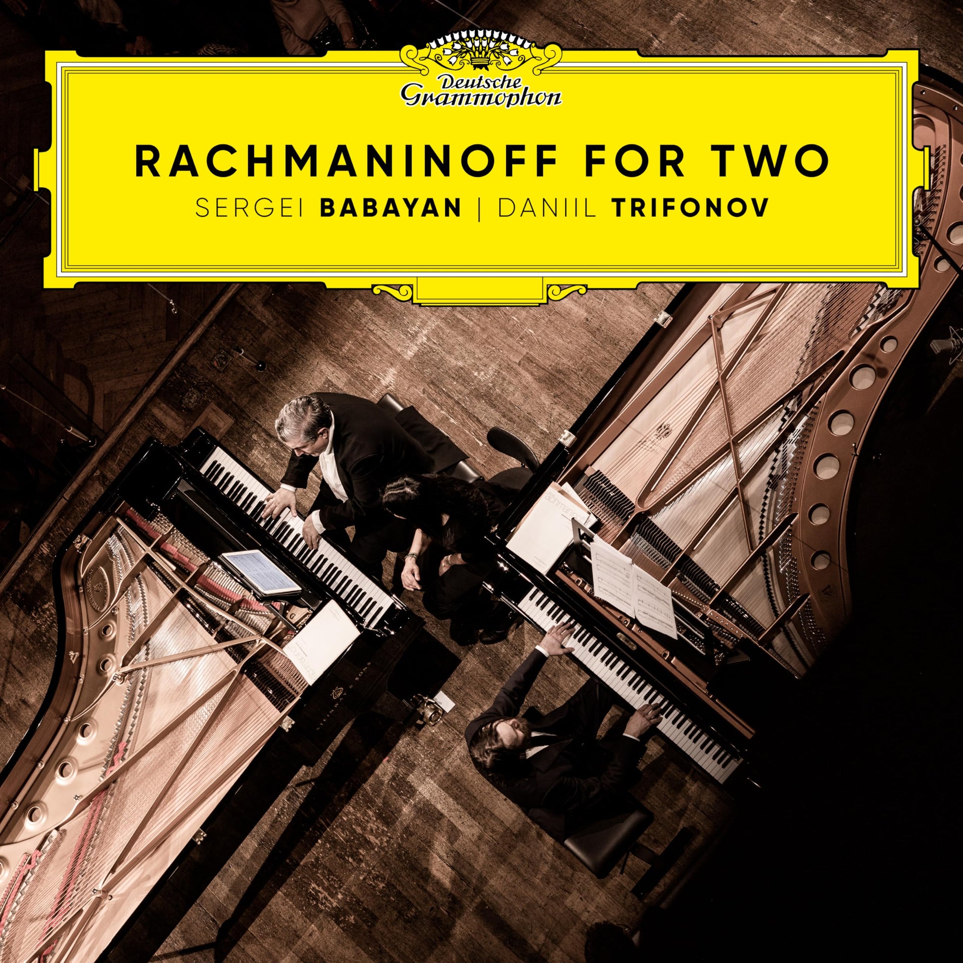 CD cover: Two pianists at grand pianos, yellow and gold design.
