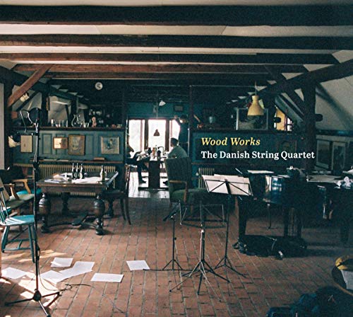 CD cover: interior room with musicians, sheet music, and rustic beams.