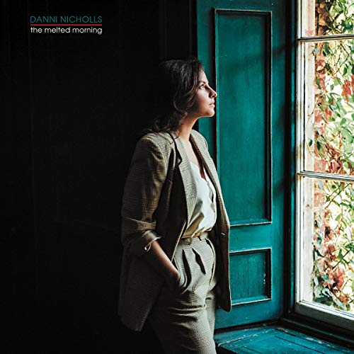 Album cover: woman in suit looking out a window.