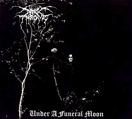 Black and white album cover with a hooded figure standing among bare trees.