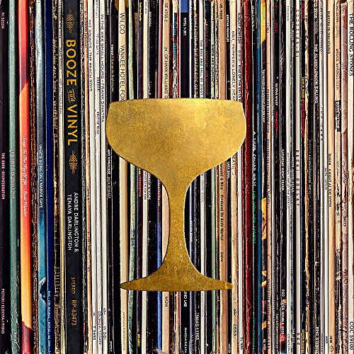 Book cover with gold cocktail glass shape against vinyl record spines.