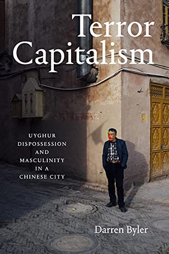 Book cover: “Terror Capitalism” with a man standing in front of a building.