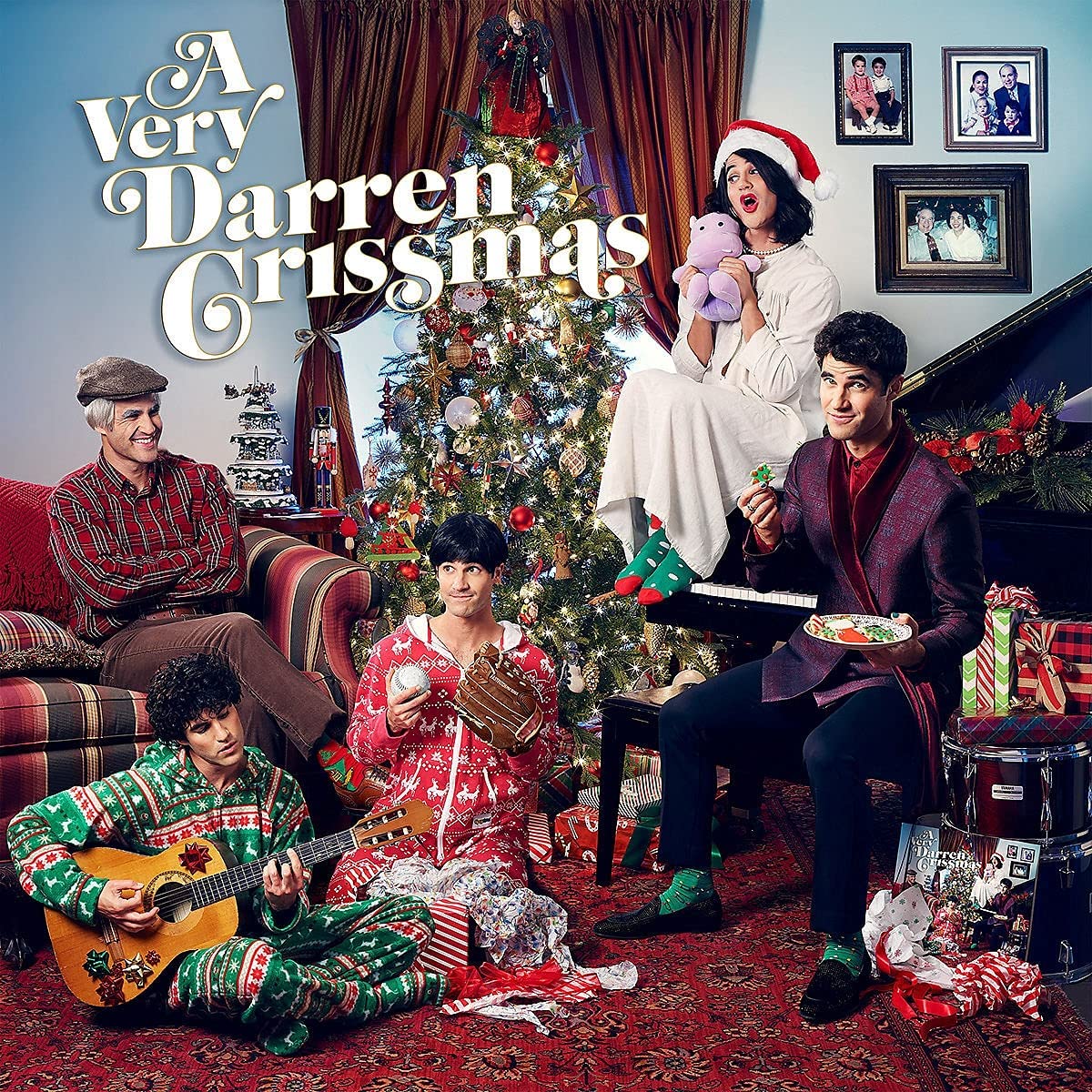 "Album cover: four people in festive attire around a Christmas tree and presents."