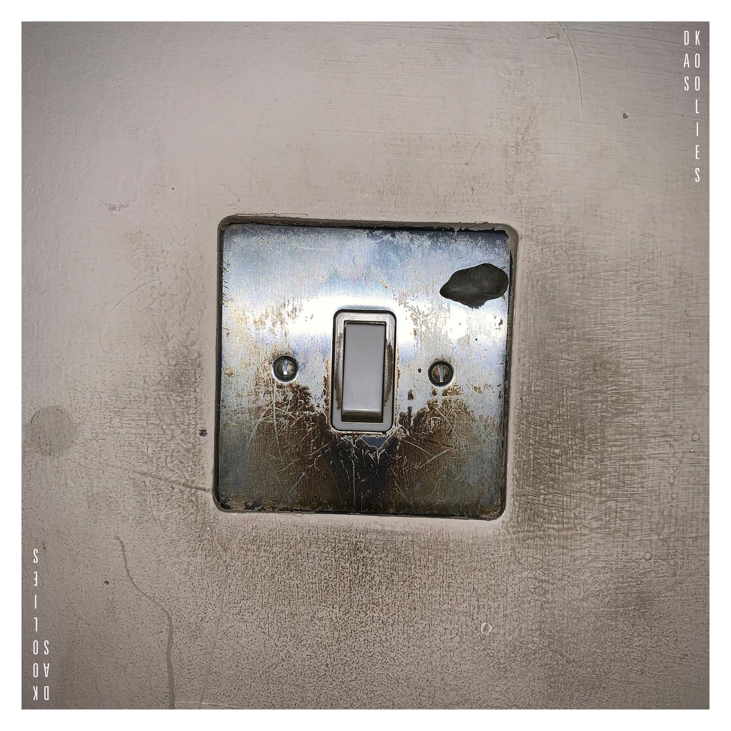 CD cover: a weathered light switch on a textured wall.