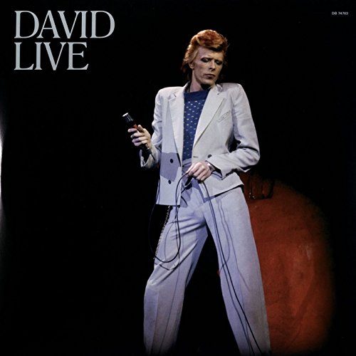 Vinyl album cover featuring David Bowie holding a microphone, wearing a white suit.