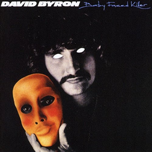 Man with glowing eyes holds an orange mask, album cover art, black background.