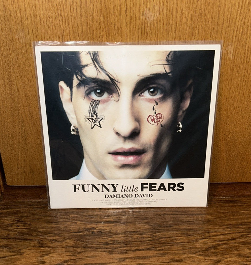 Vinyl record cover featuring a close-up portrait of Damiano David with face tattoos.