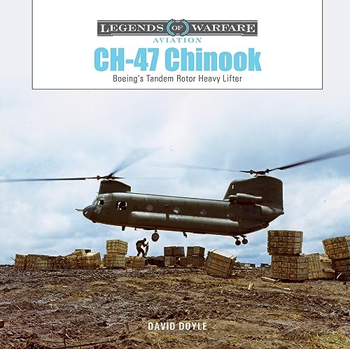 CH-47 Chinook helicopter in flight over a cargo loading area.