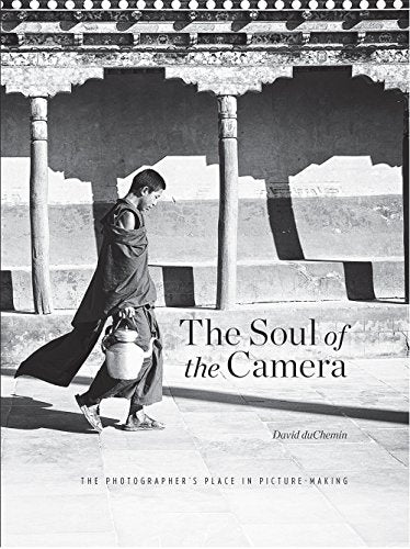 Black and white book cover featuring a young monk walking in a courtyard.