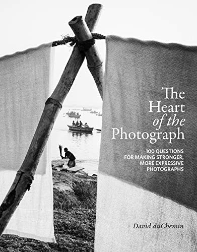 Book cover with a black and white photograph of boats and a person wading.